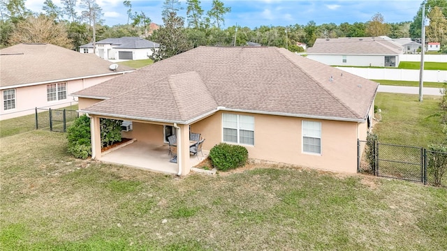 rear view of property with a patio area and a lawn