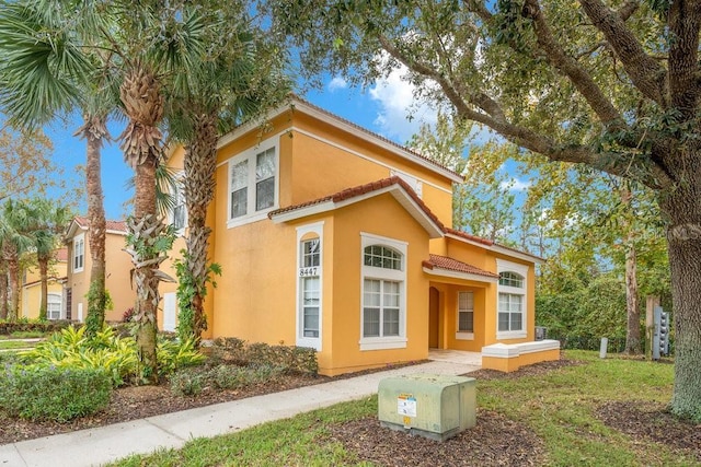 8447 Crystal Cove Loop, Kissimmee, FL 34747 - view of front of property with stucco siding and a tiled roof