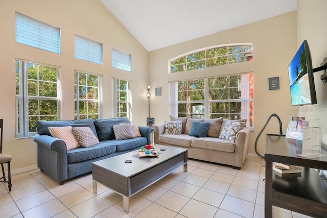 living room featuring high vaulted ceiling, plenty of natural light, and light tile patterned floors