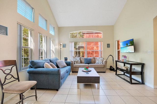 living room with high vaulted ceiling and light tile patterned floors