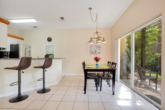 8447 Crystal Cove Loop, Kissimmee, FL 34747 - dining room featuring a chandelier, light tile patterned floors, and baseboards