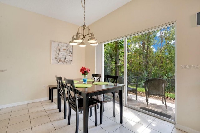 tiled dining area featuring a chandelier