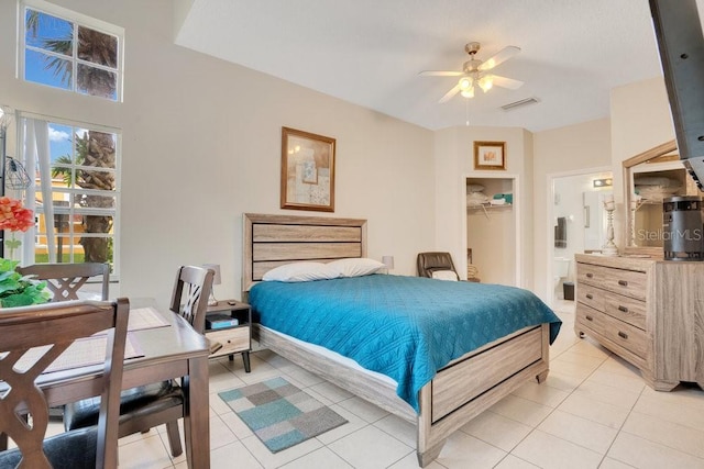 bedroom with light tile patterned floors, ceiling fan, and a closet