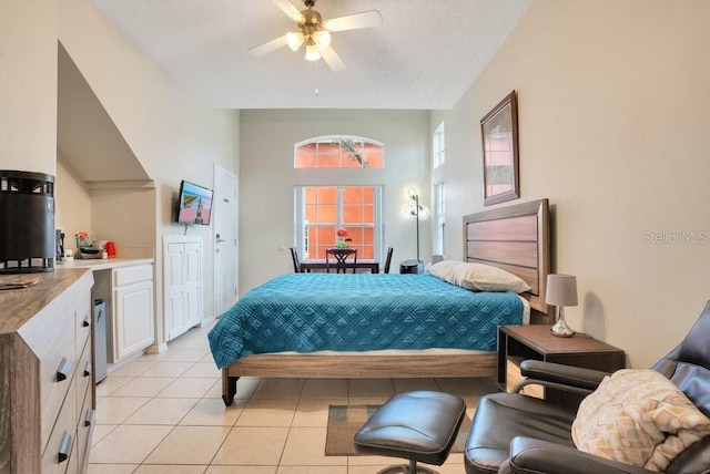 8447 Crystal Cove Loop, Kissimmee, FL 34747 - bedroom with light tile patterned floors, a textured ceiling, and ceiling fan