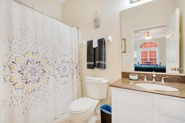 8447 Crystal Cove Loop, Kissimmee, FL 34747 - ensuite bathroom featuring toilet, vanity, ceiling fan, and a shower with shower curtain