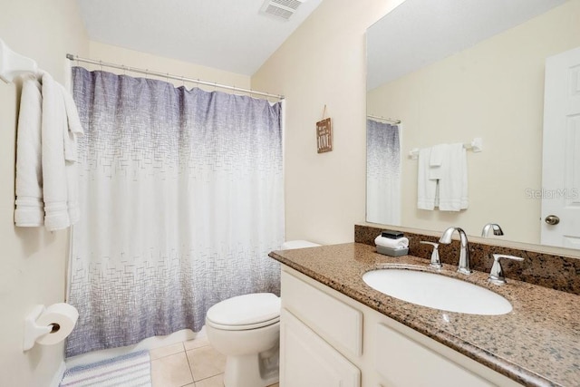 bathroom featuring toilet, vanity, and tile patterned floors