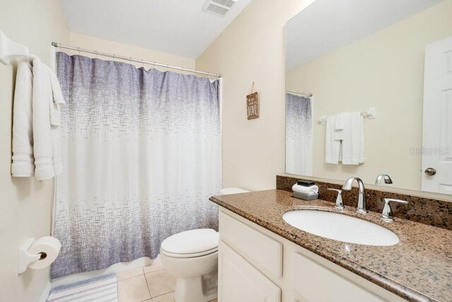 8447 Crystal Cove Loop, Kissimmee, FL 34747 - bathroom featuring toilet, tile patterned flooring, vanity, and a shower with curtain