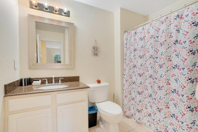 bathroom featuring walk in shower, tile patterned flooring, vanity, and toilet