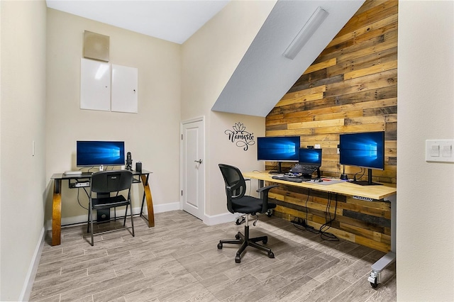 home office with wooden walls and light wood-type flooring