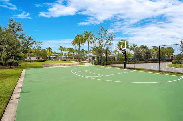 view of sport court featuring a lawn