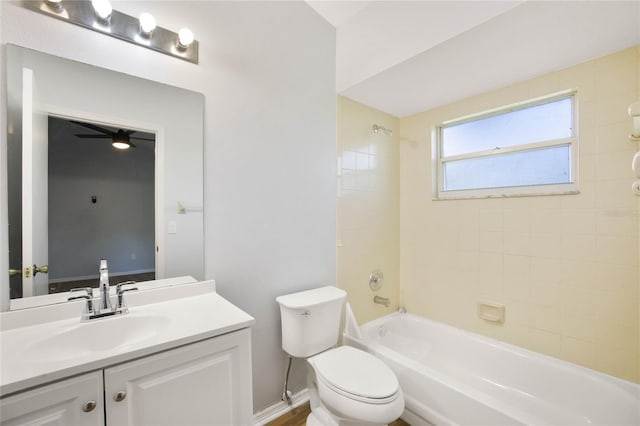 full bathroom with vanity, tiled shower / bath combo, toilet, and ceiling fan