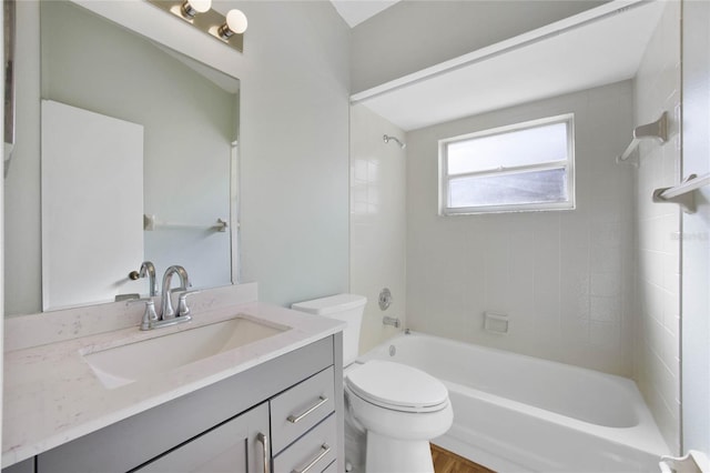 full bathroom with tiled shower / bath, toilet, and vanity