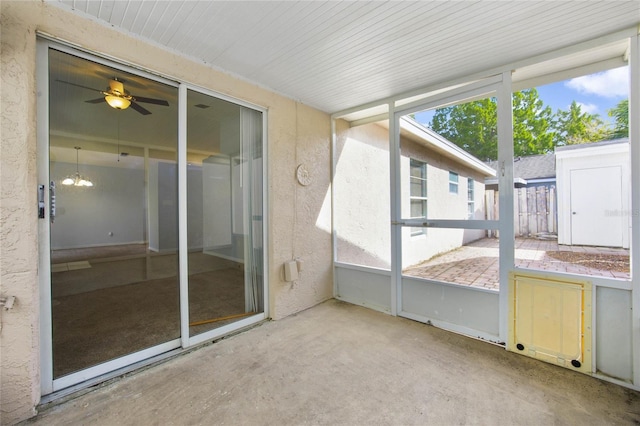 unfurnished sunroom featuring ceiling fan