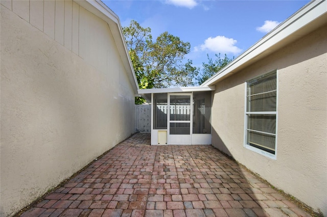 view of patio featuring a sunroom