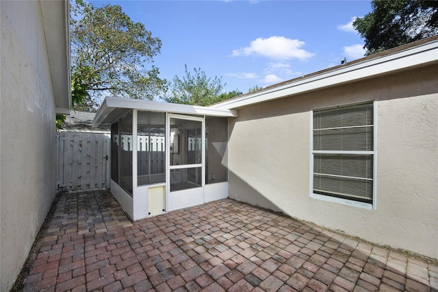 view of patio with a sunroom