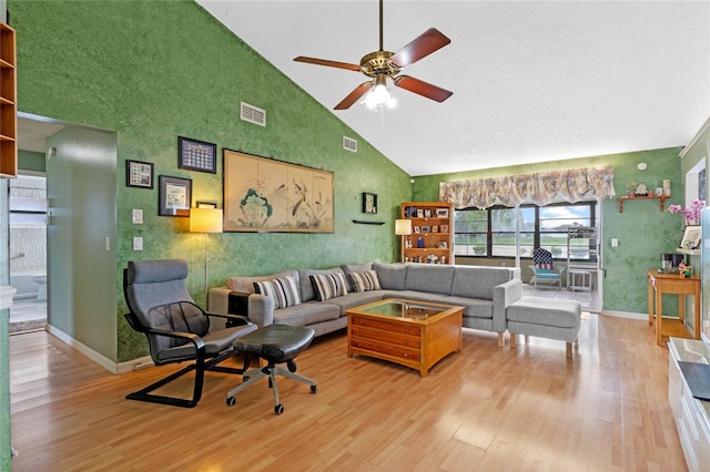 living room with high vaulted ceiling, ceiling fan, and light hardwood / wood-style flooring