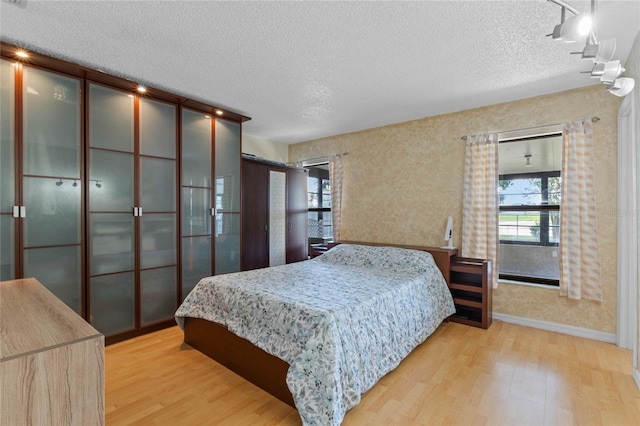 bedroom featuring wood-type flooring and a textured ceiling