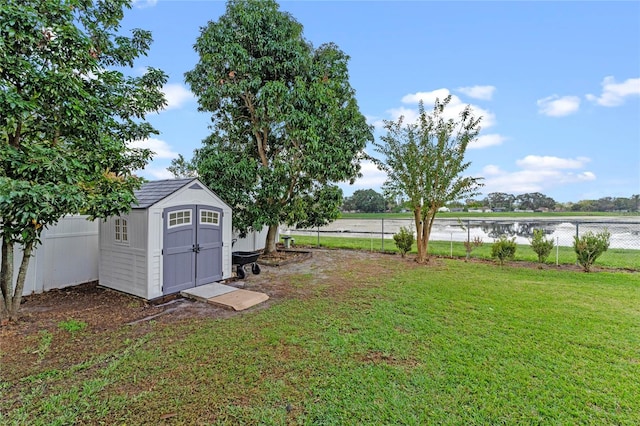 view of yard with a storage unit and a water view