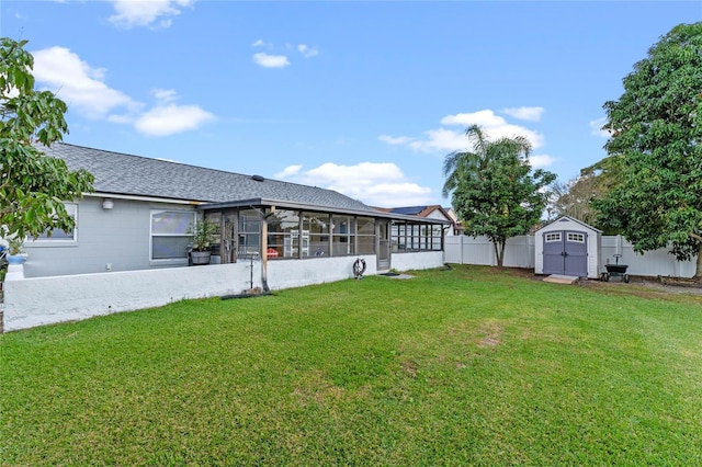 view of yard featuring a sunroom and a storage shed