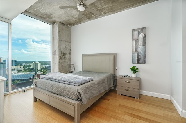 bedroom with light hardwood / wood-style floors and ceiling fan