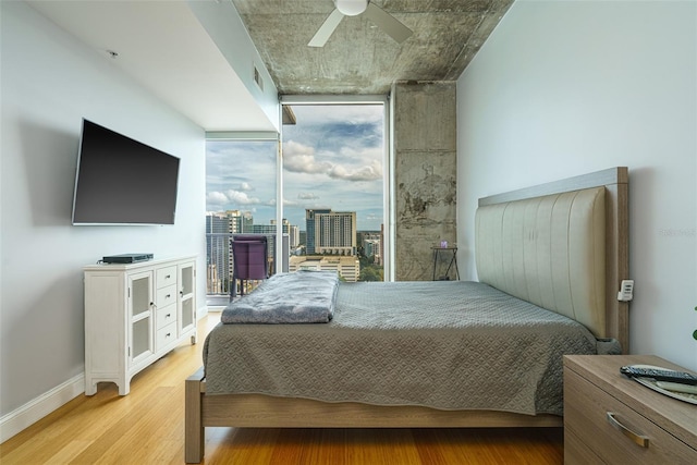 bedroom with light hardwood / wood-style floors and ceiling fan