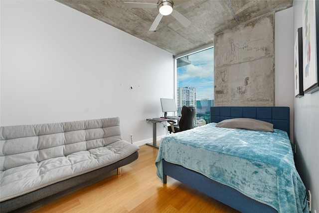 bedroom with hardwood / wood-style floors and ceiling fan