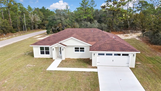 view of front of home with a front lawn and a garage