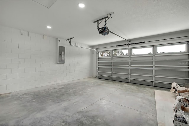 garage with electric panel and a garage door opener