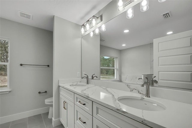 bathroom with vanity, toilet, and tile patterned floors