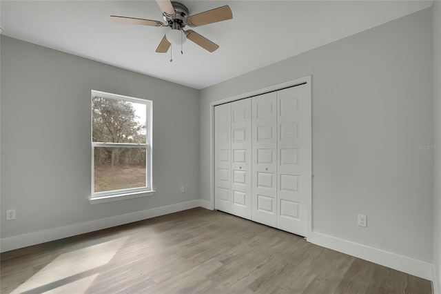 unfurnished bedroom featuring a closet, light hardwood / wood-style floors, and ceiling fan