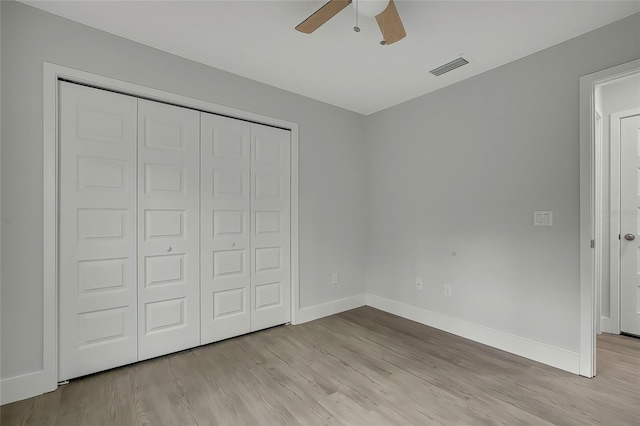 unfurnished bedroom featuring ceiling fan, a closet, and light hardwood / wood-style floors