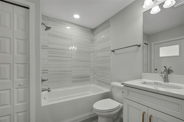 full bathroom with vanity, toilet, and tiled shower / bath combo