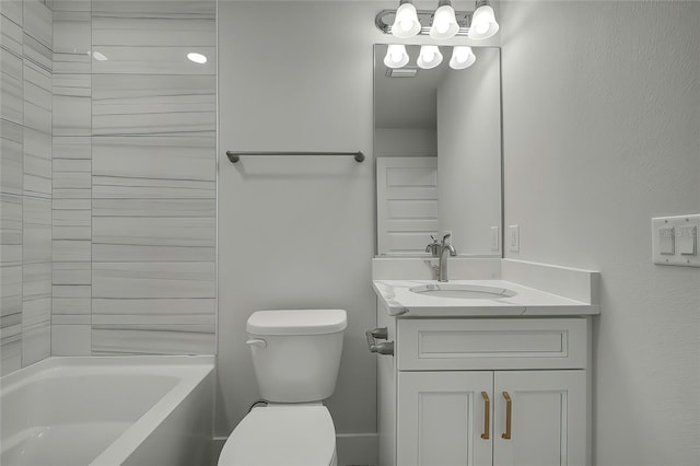 full bathroom featuring tiled shower / bath, vanity, and toilet