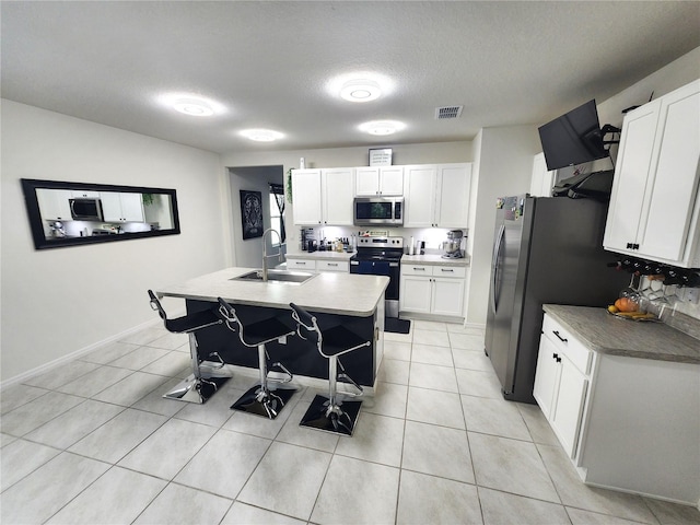 kitchen with white cabinets, appliances with stainless steel finishes, and sink