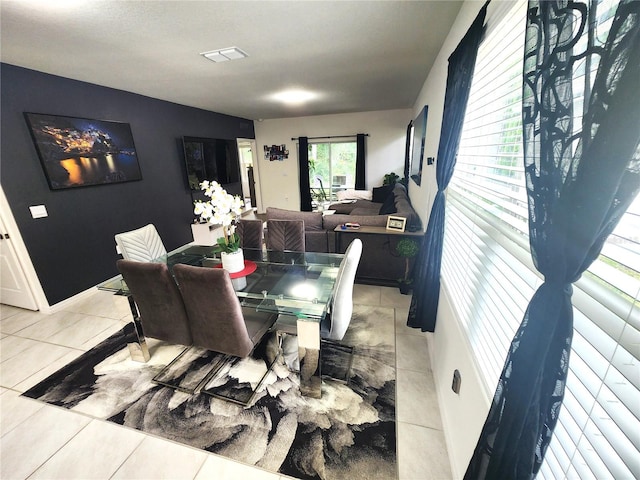 dining area with light tile patterned flooring