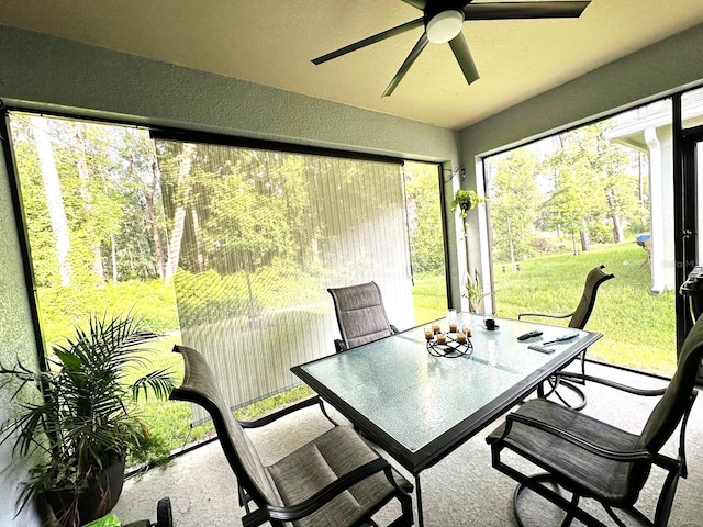 sunroom featuring ceiling fan