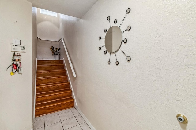 stairway featuring tile patterned flooring