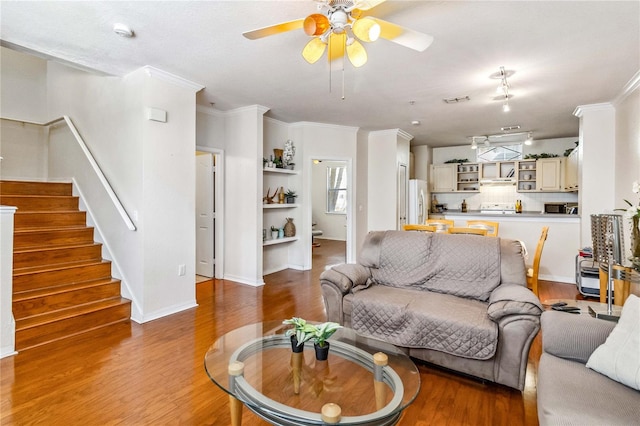 living room with ceiling fan, ornamental molding, and hardwood / wood-style flooring