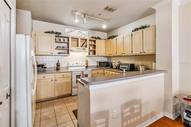 kitchen featuring white appliances, light tile patterned floors, tasteful backsplash, kitchen peninsula, and extractor fan