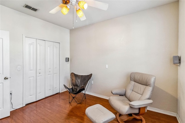 sitting room featuring hardwood / wood-style floors and ceiling fan