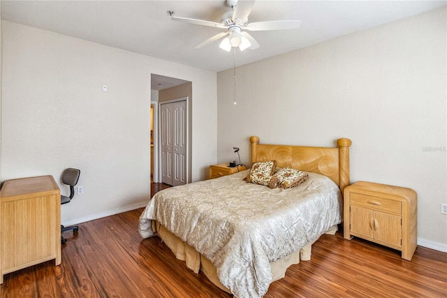 bedroom with a closet, hardwood / wood-style flooring, and ceiling fan