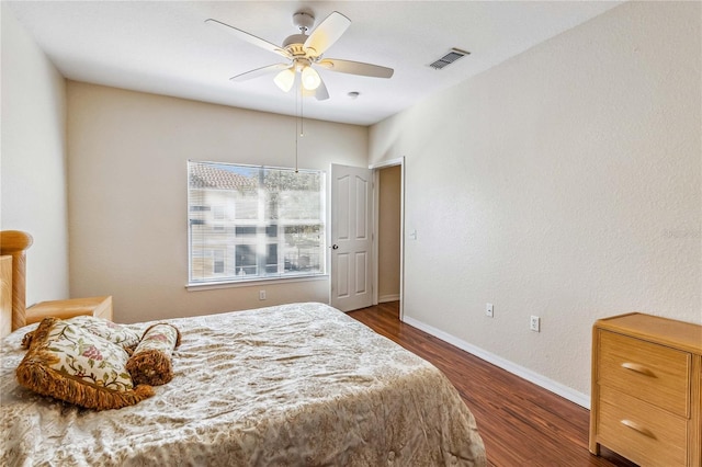 bedroom featuring dark hardwood / wood-style flooring and ceiling fan