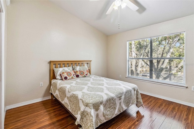 bedroom with dark hardwood / wood-style floors, ceiling fan, and lofted ceiling