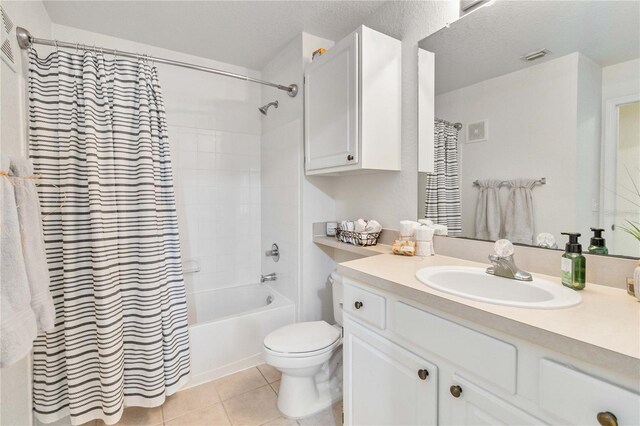 full bathroom featuring vanity, tile patterned flooring, toilet, a textured ceiling, and shower / tub combo