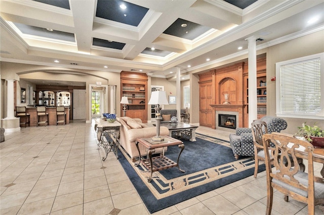 tiled living room featuring beamed ceiling, decorative columns, ornamental molding, and coffered ceiling