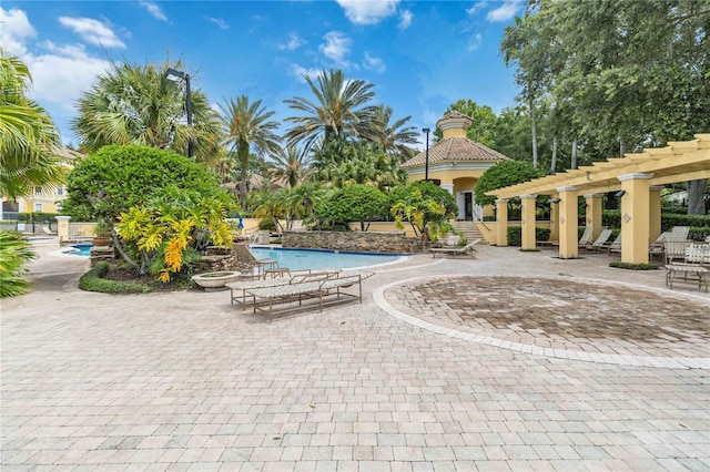 view of swimming pool featuring a pergola and a patio area