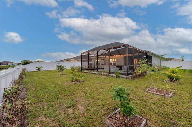 view of yard with glass enclosure and a patio area