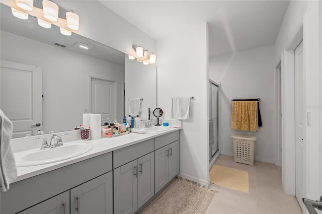 bathroom with vanity, tile patterned flooring, and a shower with door