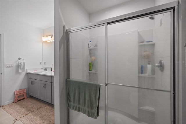 bathroom featuring vanity and a shower with door