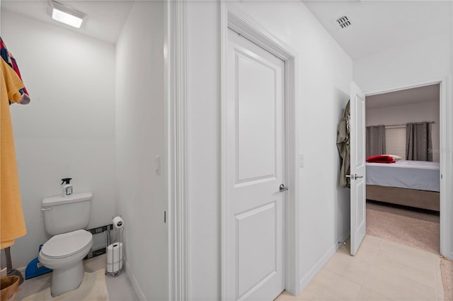 bathroom featuring toilet and tile patterned floors